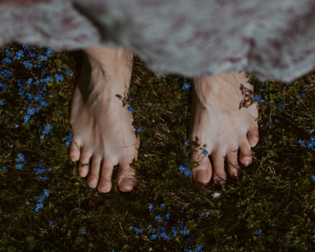 Clients practicing grounding exercises barefoot on natural earth.