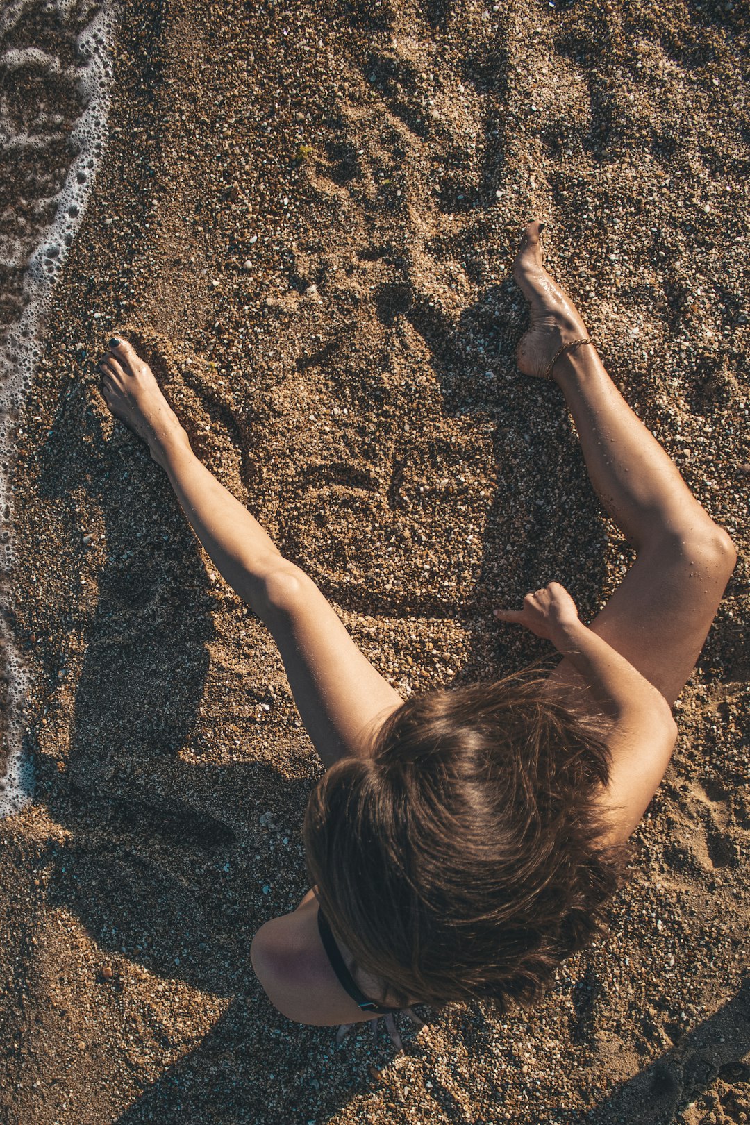 girl in black shirt on brown sand during daytime