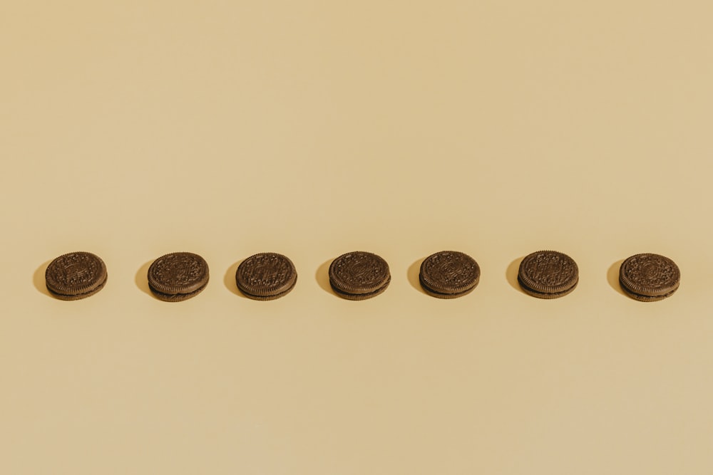 eight round gold coins on white surface