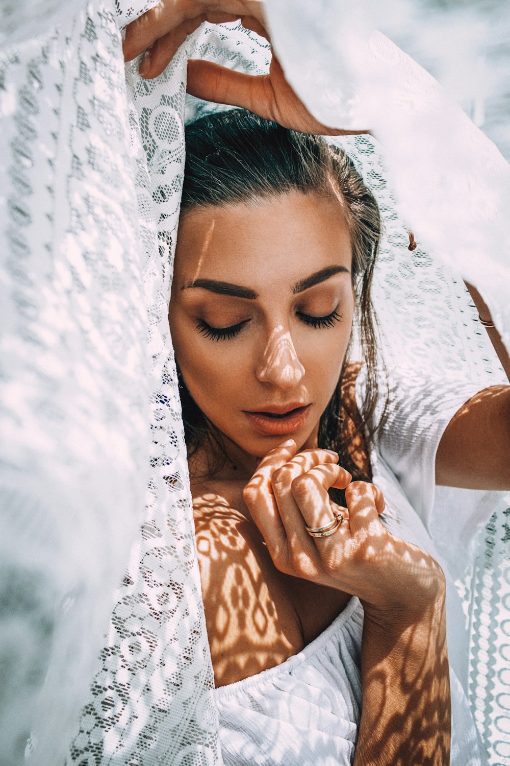 woman in white lace floral hijab