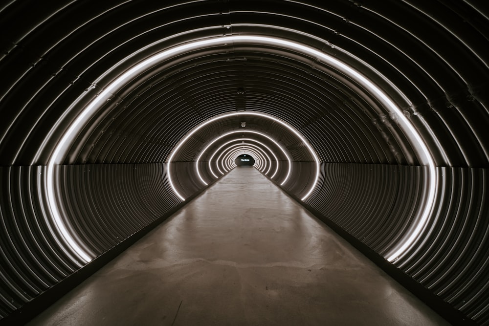 gray tunnel with light turned on during daytime