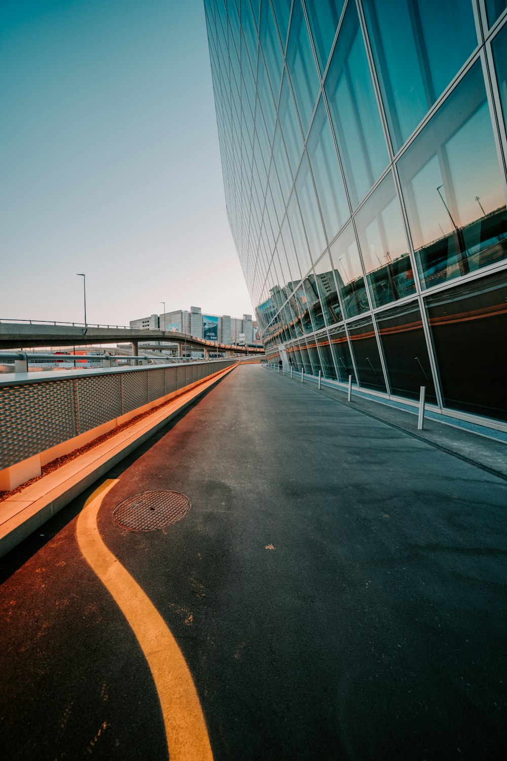 gray concrete road near white and gray building during daytime