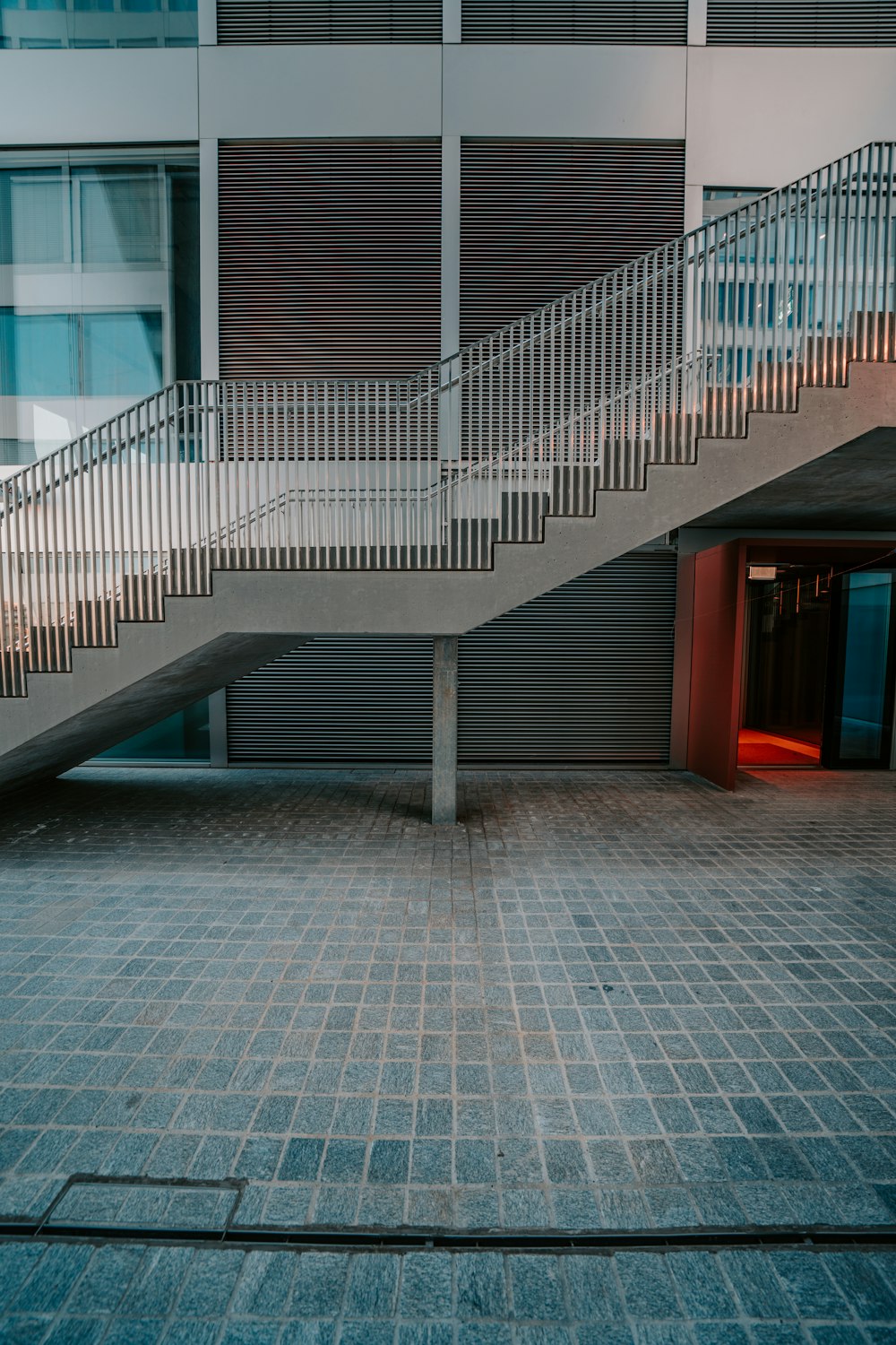 red wooden door on gray concrete building