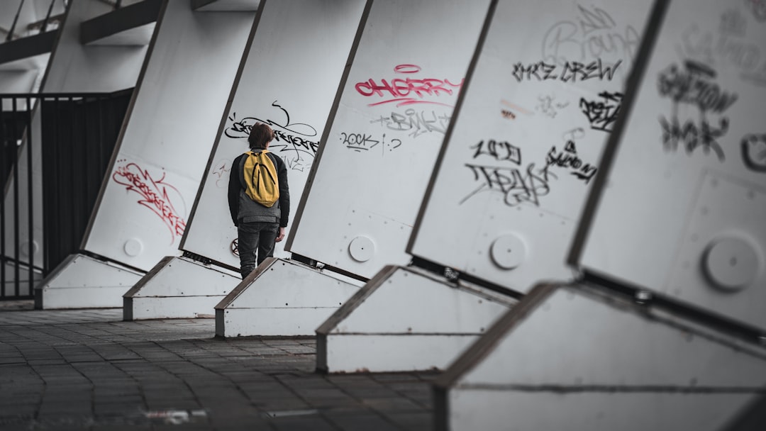 man in yellow and black jacket standing on stairs