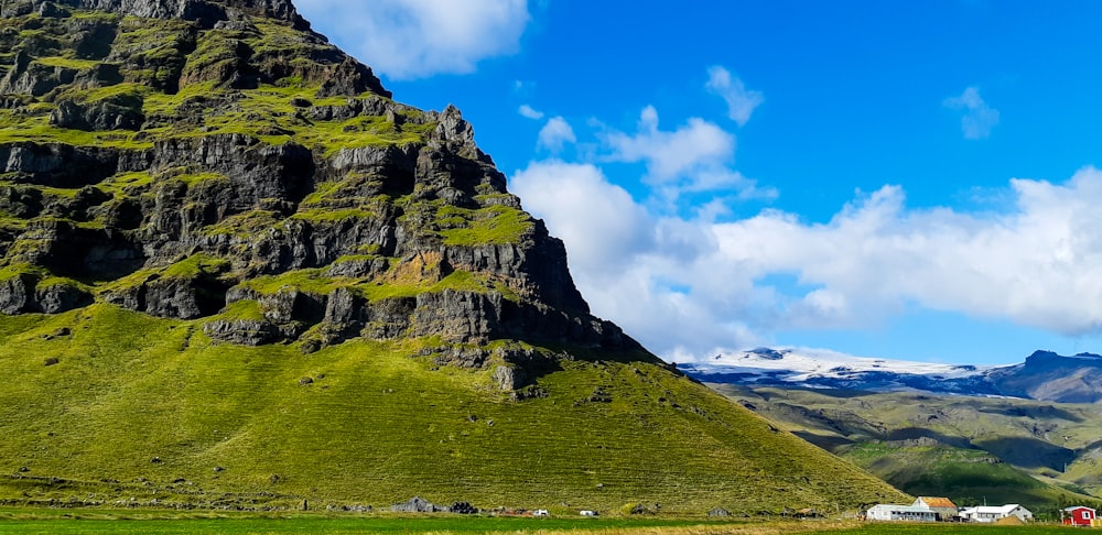green grass covered mountain under blue sky during daytime