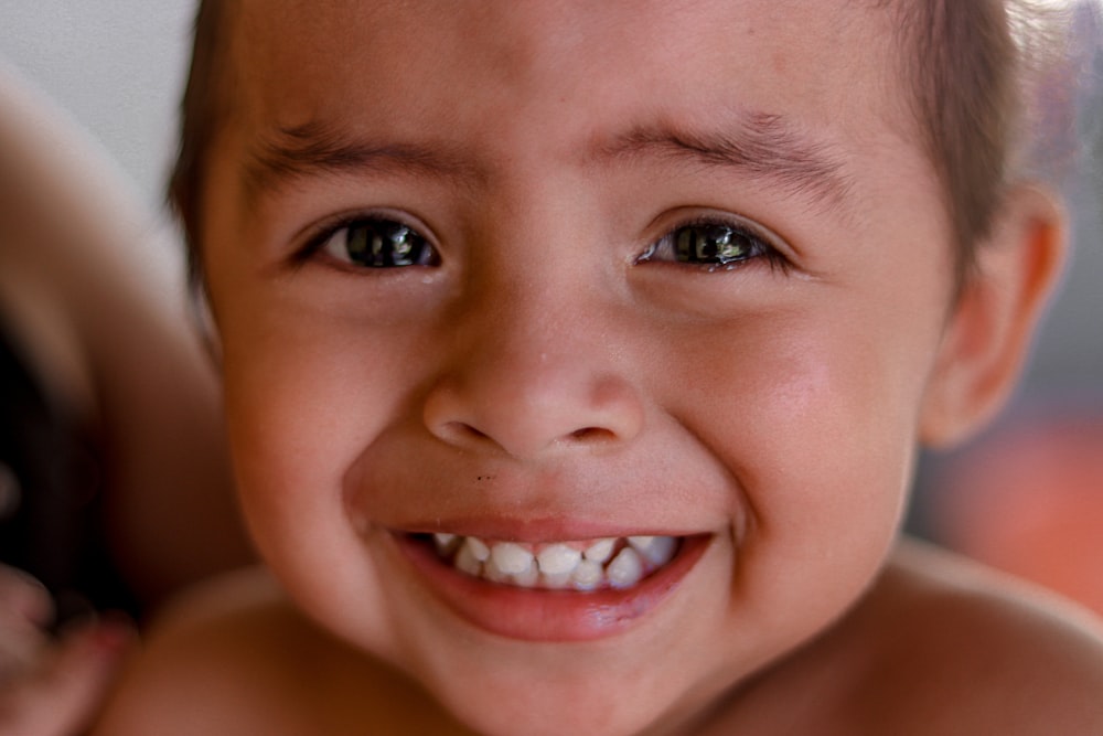 smiling boy with eyes closed