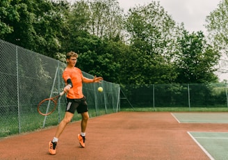 woman in black tank top playing tennis during daytime