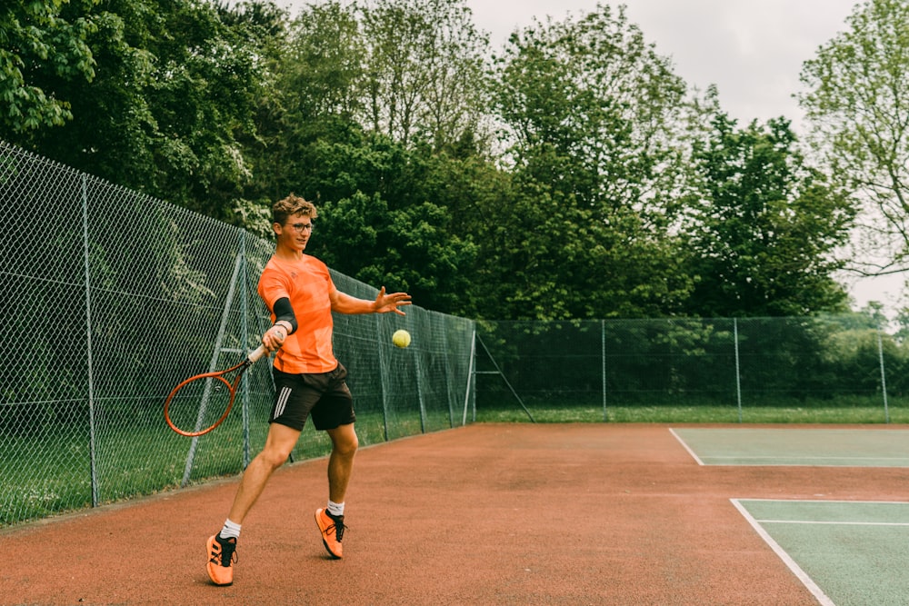 woman in black tank top playing tennis during daytime