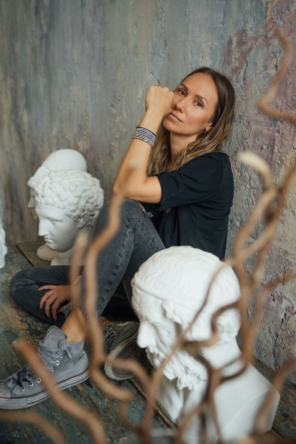 woman in black t-shirt sitting on floor with white cotton