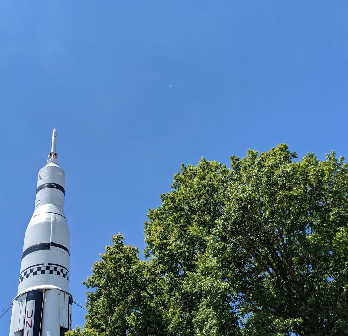 Saturn V rocket standing against a blue sky in Huntsville, Alabama, the Rocket City