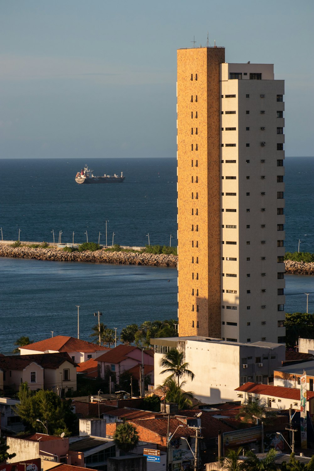 brown concrete building near body of water during daytime