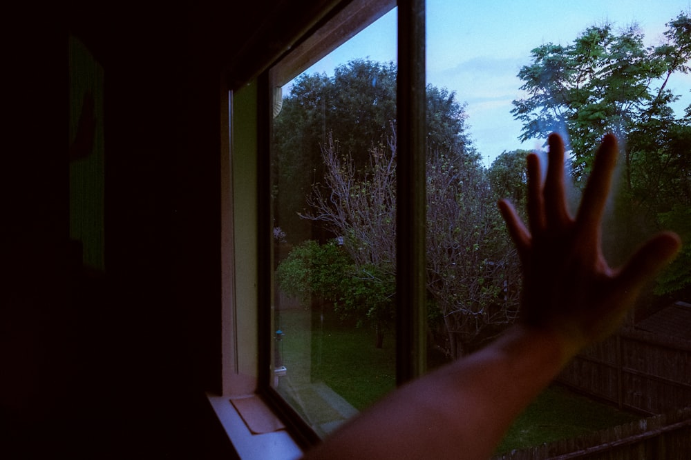 persons hand near window
