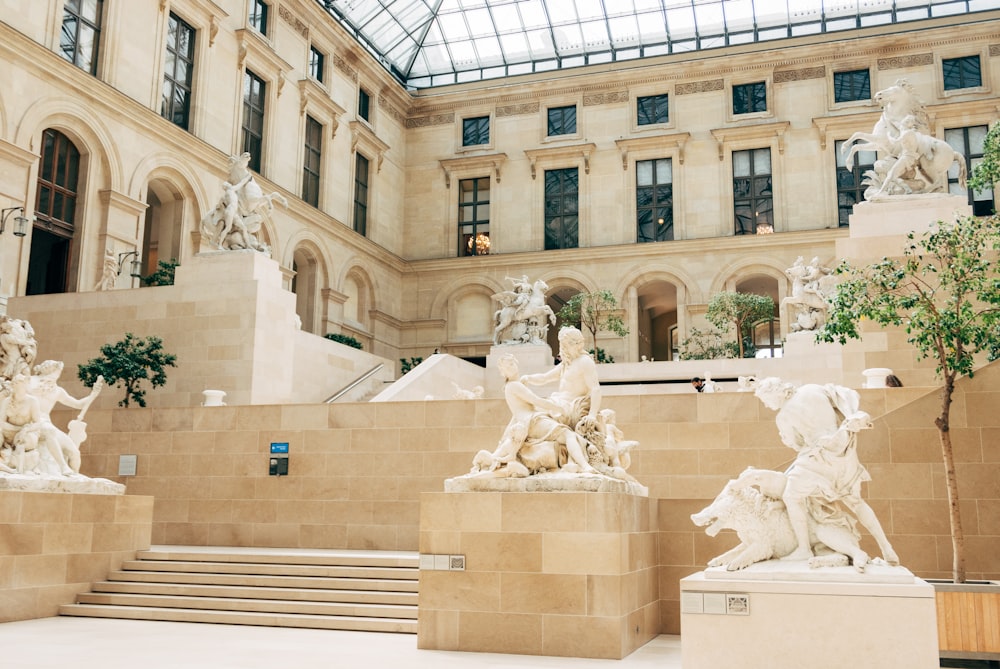 white concrete building with statues