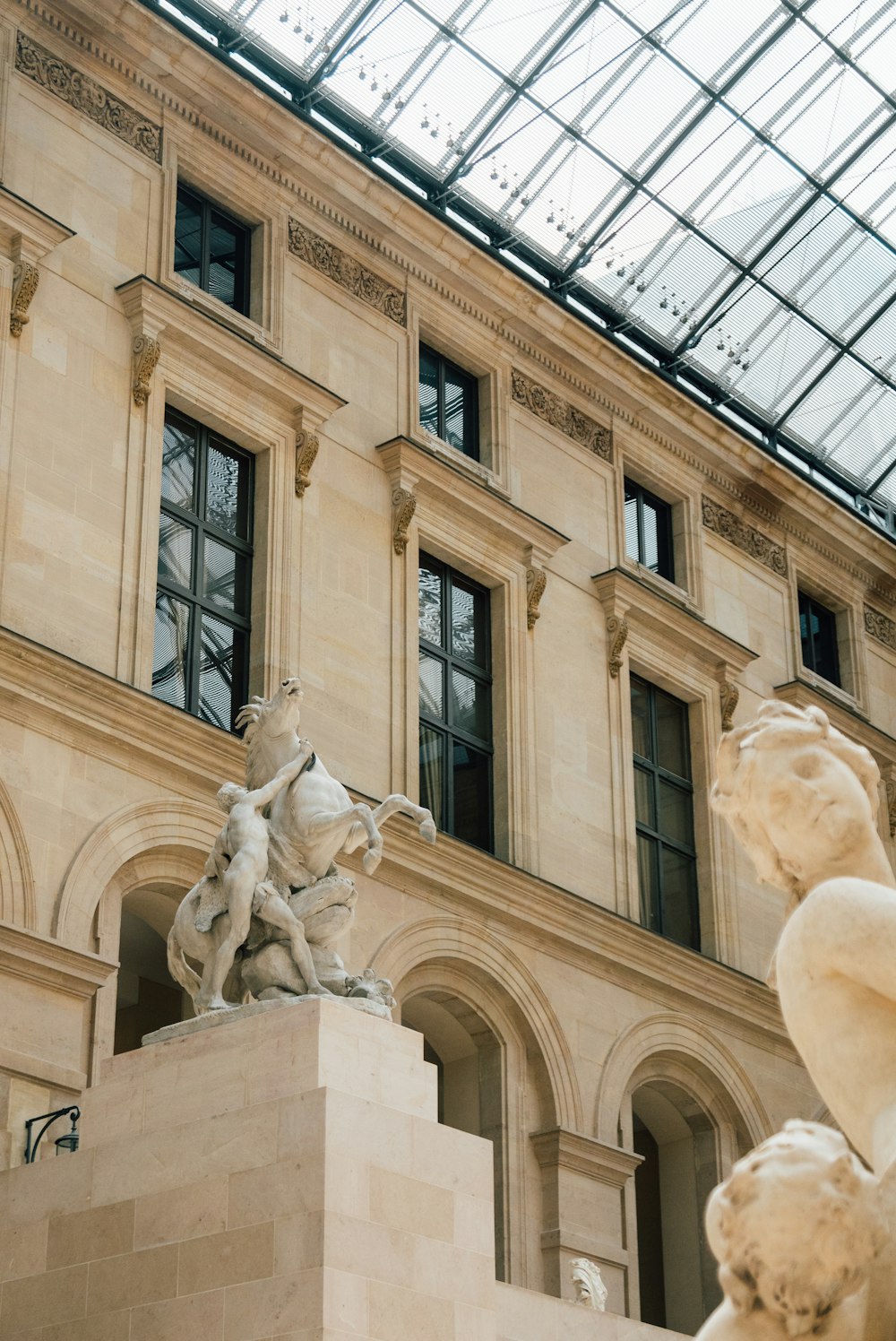 white concrete building with statues