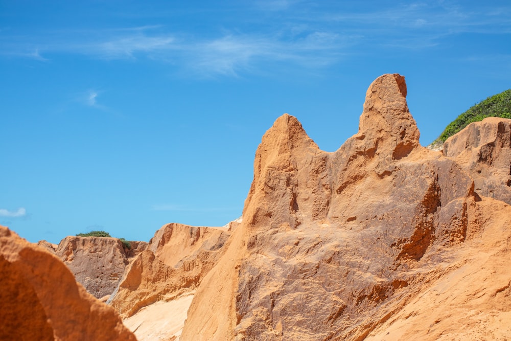 brown rocky mountain under blue sky during daytime