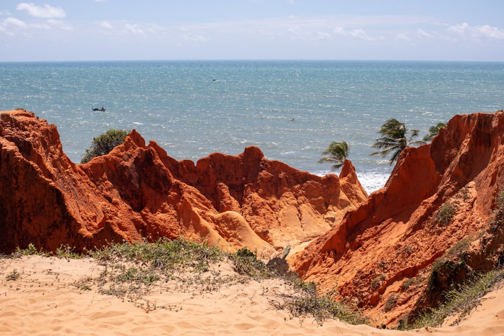 brown rock formation near body of water during daytime