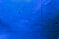 Detail of a freshly painted blue accent wall inside a renovated commercial space.