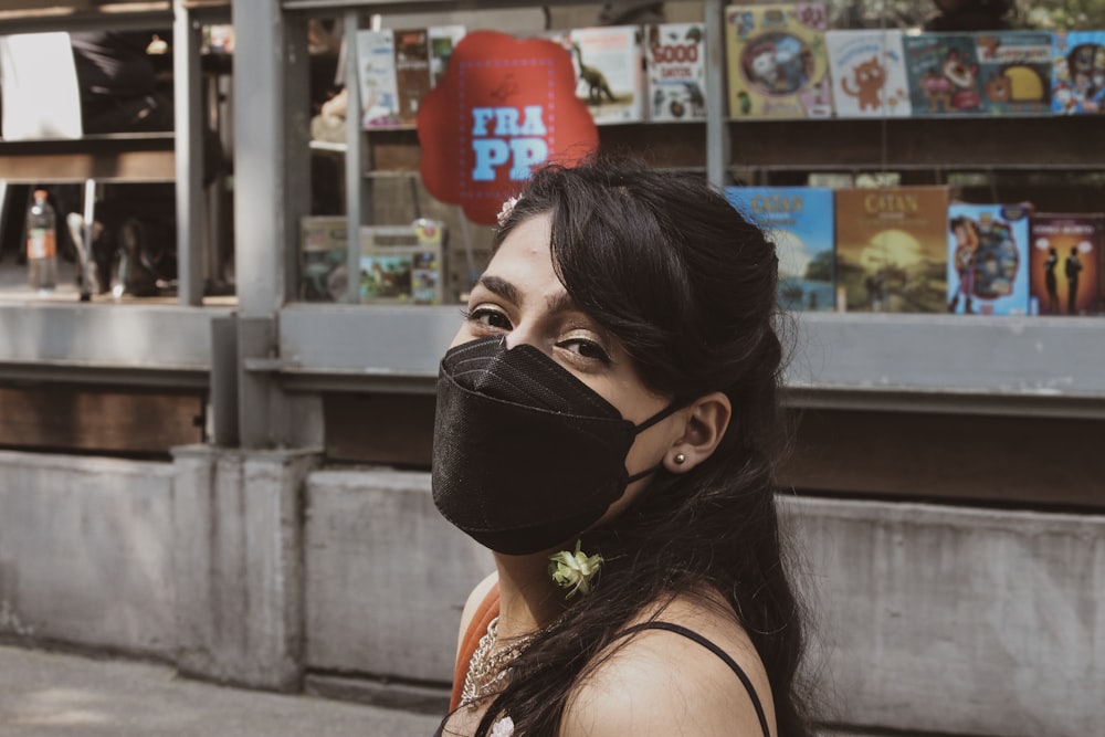 woman in black mask and orange tank top