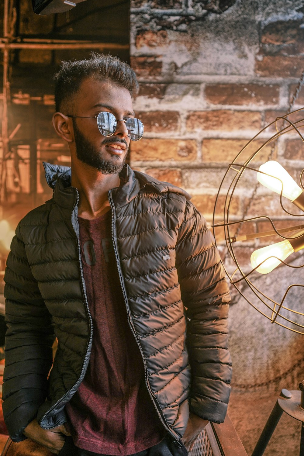 man in brown leather jacket wearing black sunglasses