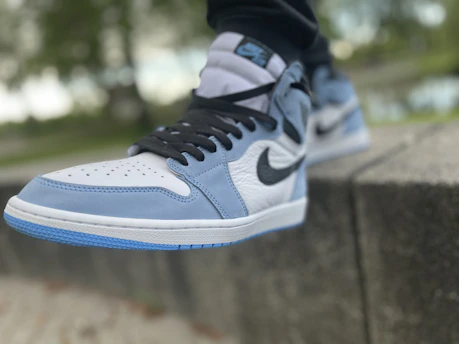 A close-up of a rare Nike sneaker with vibrant electric green accents, resting on a sleek black surface.