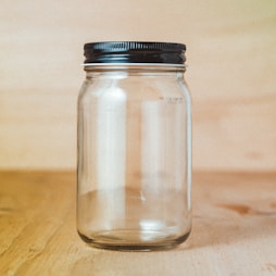 clear glass jar with white powder inside