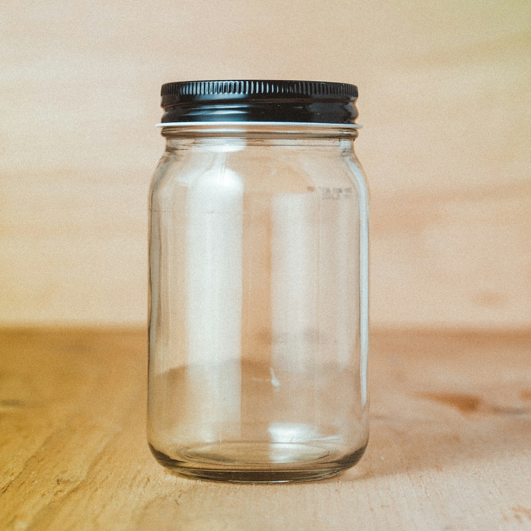  clear glass jar with white powder inside bottle