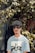 man in blue and white striped crew neck shirt wearing black sunglasses standing beside green plants