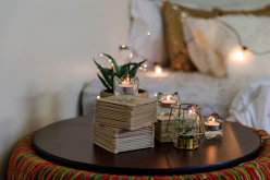 Cozy birthday party scene with intimate table settings and warm cream linens.