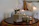 A cozy wedding table setting featuring elegant artisan candles glowing warmly.