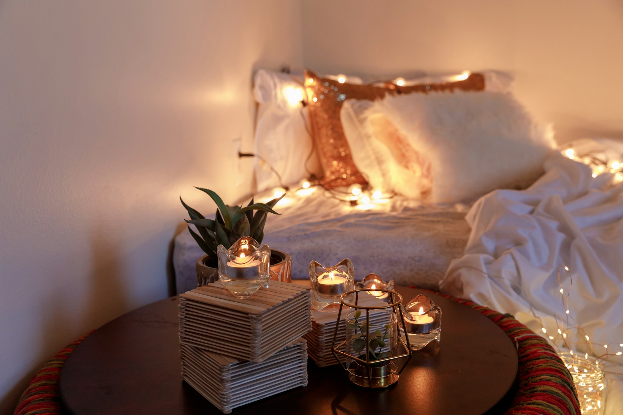 a cozy boho room decor with candles and string lights