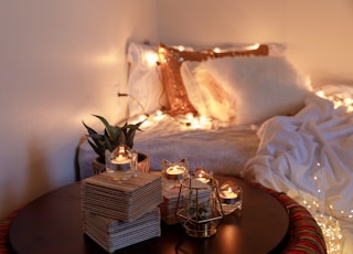 clear glass candle holder on brown wooden table