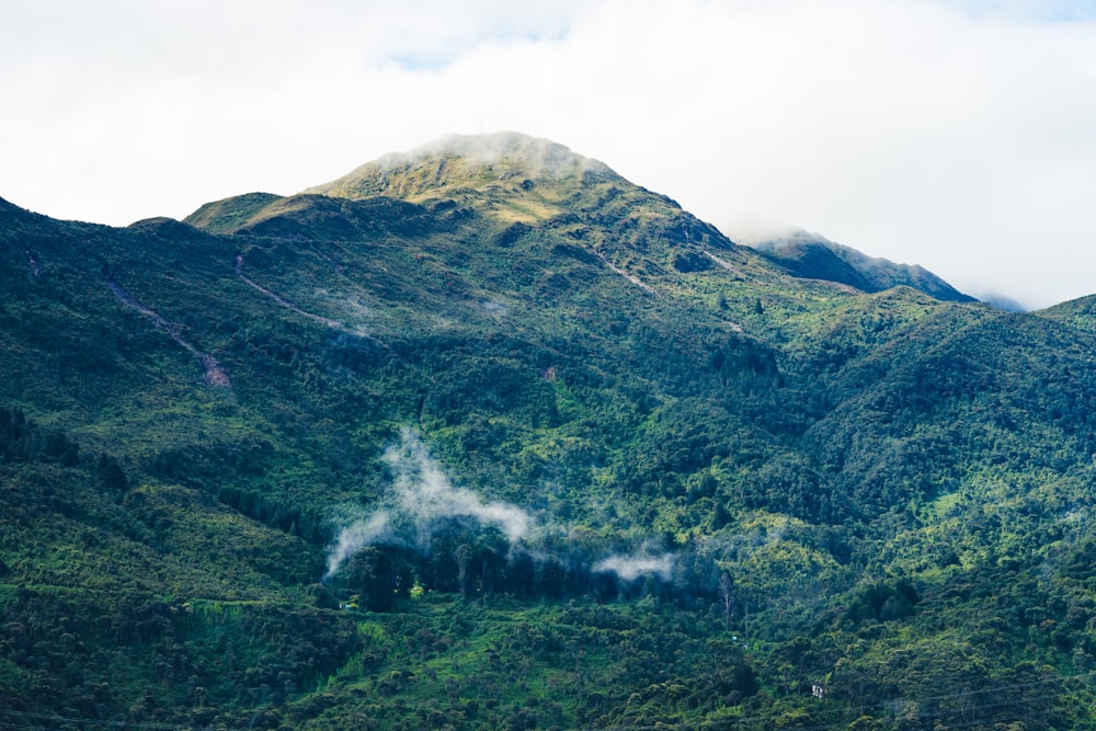 green and brown mountain under white clouds during daytime