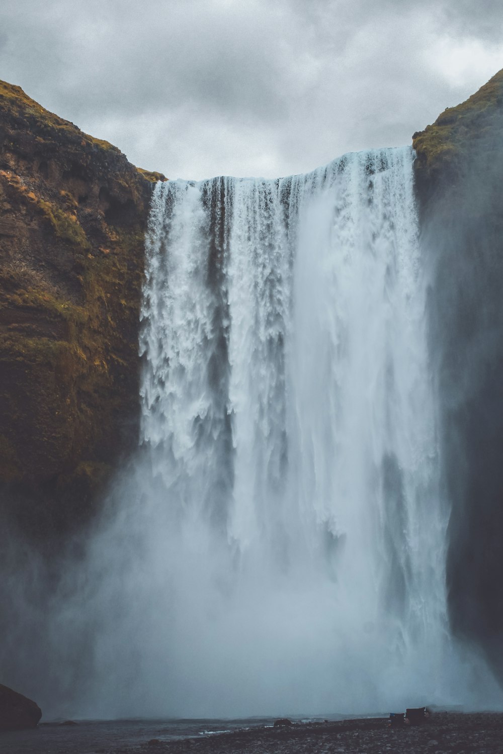 waterfalls on brown rocky mountain during daytime