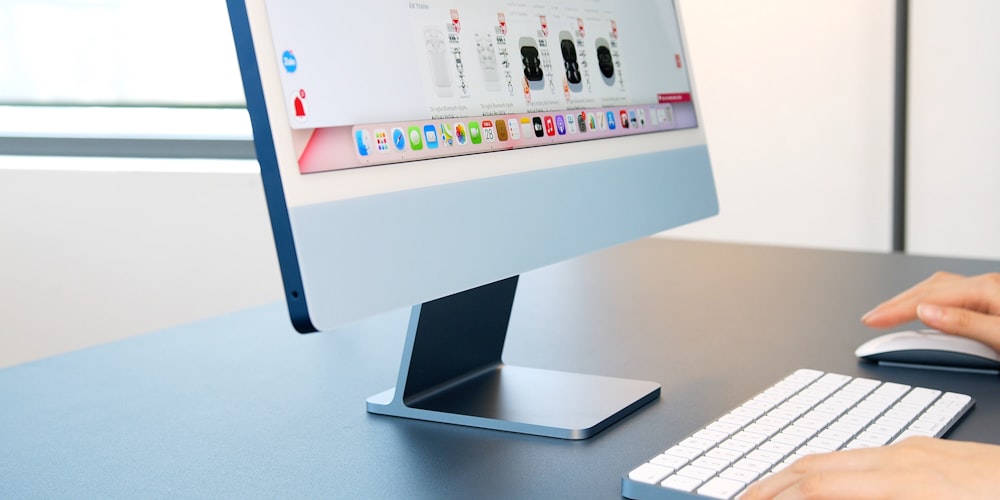 silver imac on white table