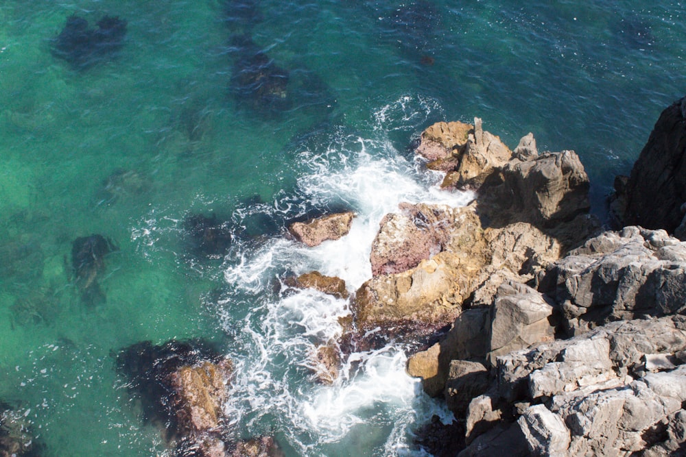 brown rocky shore with water waves