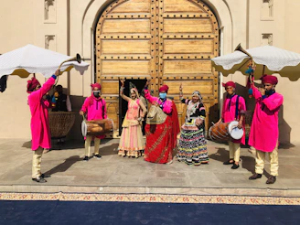 people in traditional dress dancing on street during daytime
