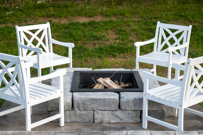 Stone outdoor fireplace with raised flagstone hearth and fieldstone surround