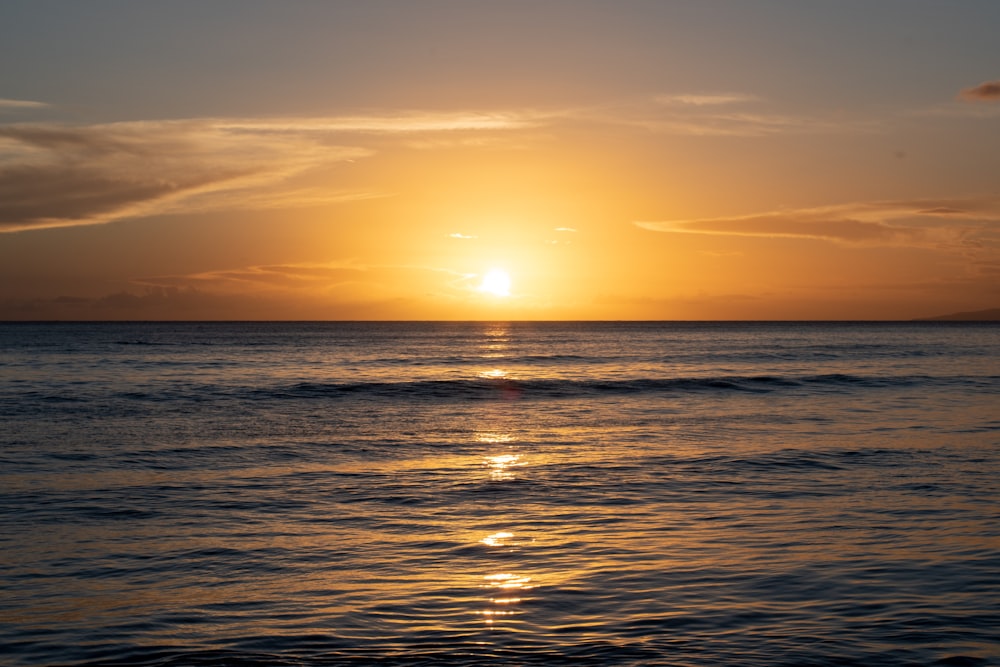 body of water during sunset