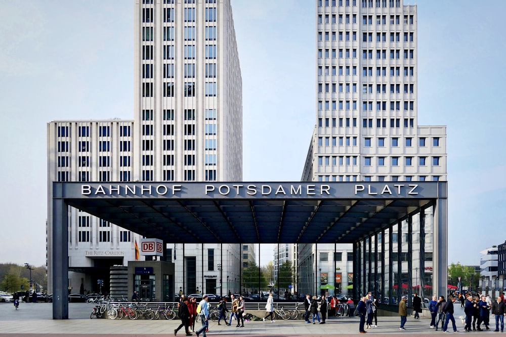 people walking on street near gray concrete building during daytime