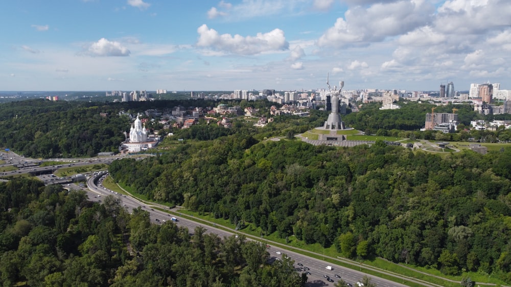 green trees and white buildings during daytime