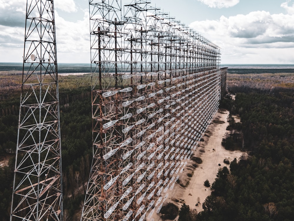 gray metal tower under white clouds during daytime