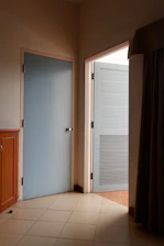 A cozy room divided by a sleek partition panel with a solid door handle and a fabric door curtain softly draped.