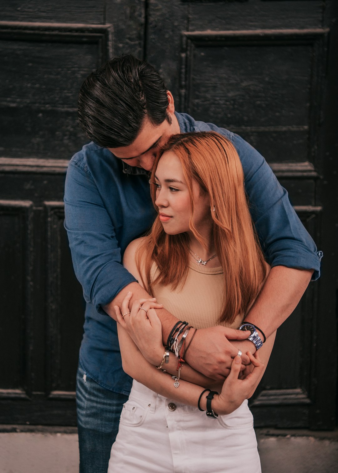 woman in blue long sleeve shirt hugging woman in blue denim jeans