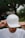 person in white long sleeve shirt holding white hat
