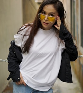 woman in white crew neck shirt and black jacket wearing sunglasses