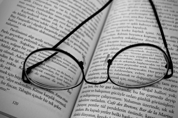 black framed eyeglasses on book page