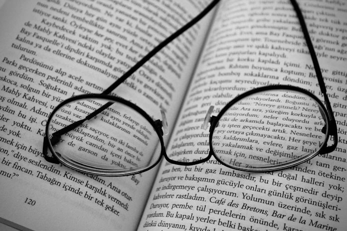 black framed eyeglasses on book page