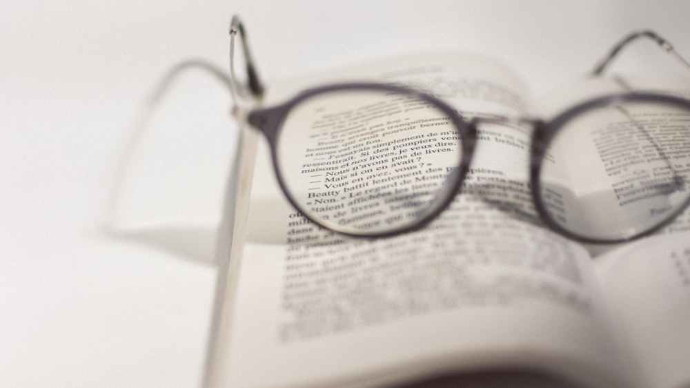 black framed eyeglasses on white book page