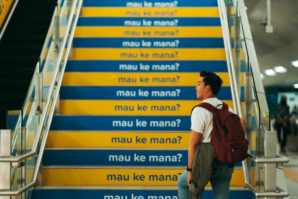 man in white shirt and brown pants walking on a ladder