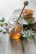 A rustic wooden table with a jar of pureharvest organics honey dripping from a honey dipper.